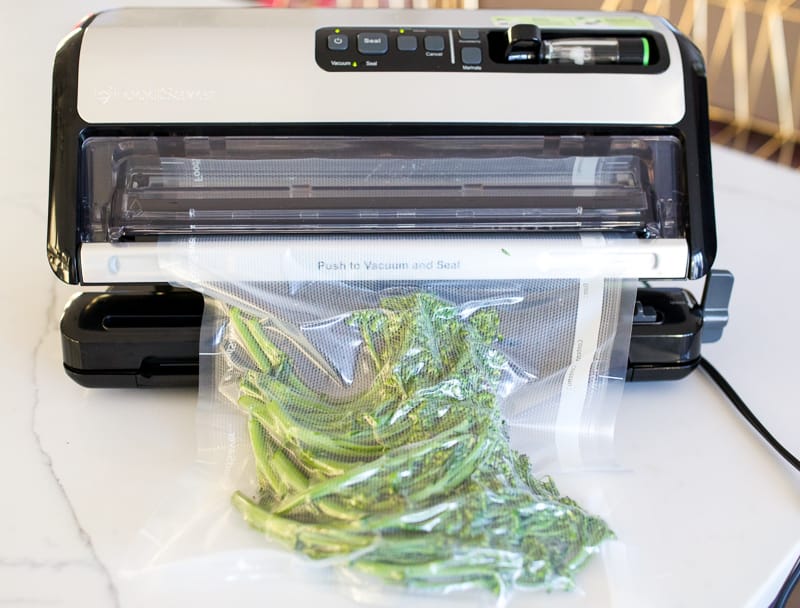 Foodsaver vacuum sealer sealing broccolini.