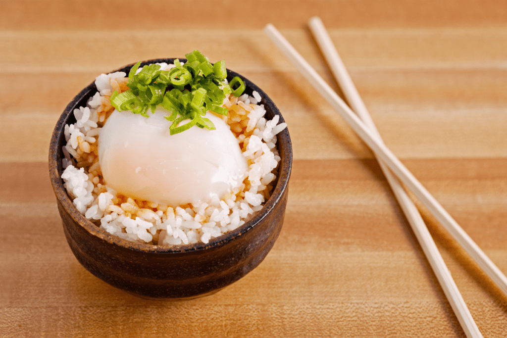 Onsen egg in a bowl atop rice with scallion garnish