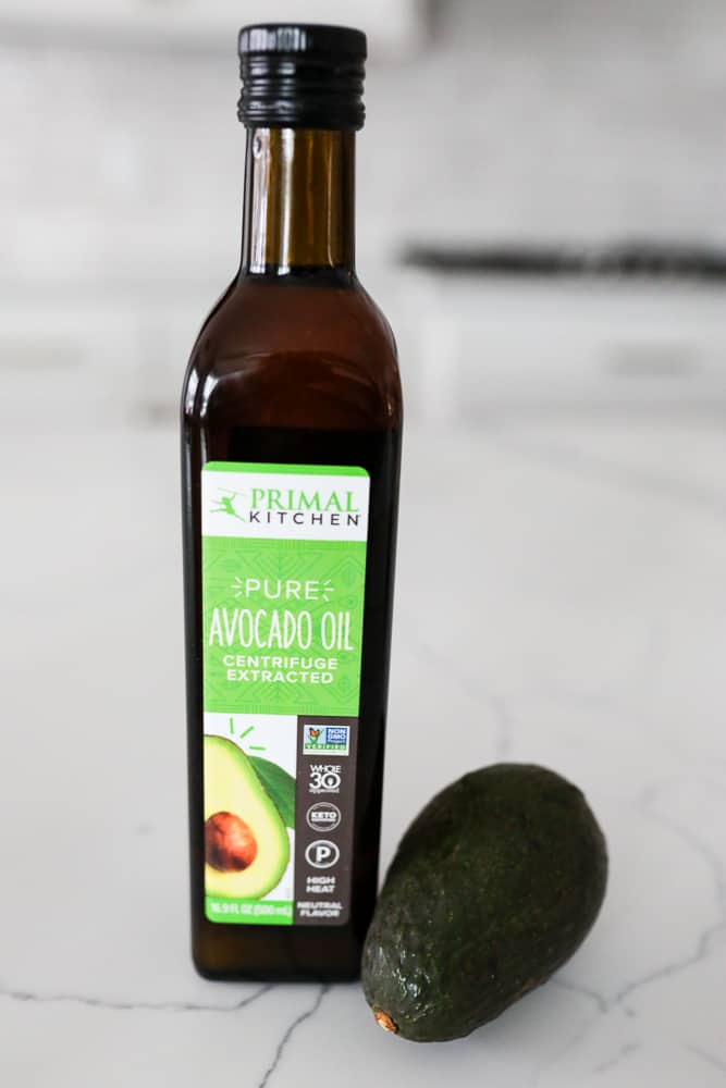 Bottle of Primal Kitchen Avocado Oil with an avocado at the base of the bottle.