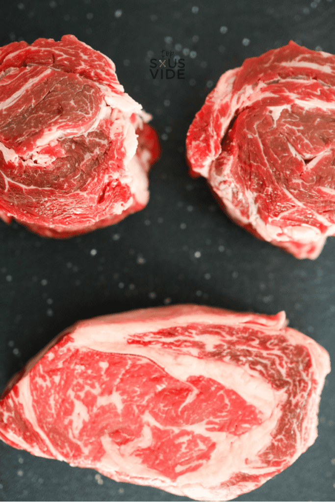 closeup of two spinalis steaks and a ribeye steak