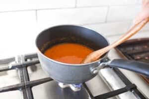 hot sauce being stirred in pot