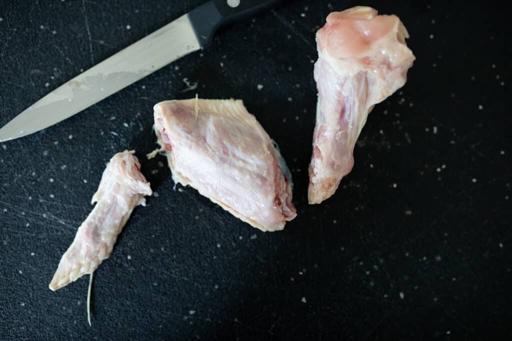 Whole chicken wing cut in three pieces: flat, drumette, tip.