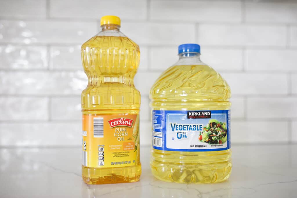 Bottle of corn oil and bottle of vegetable oil.