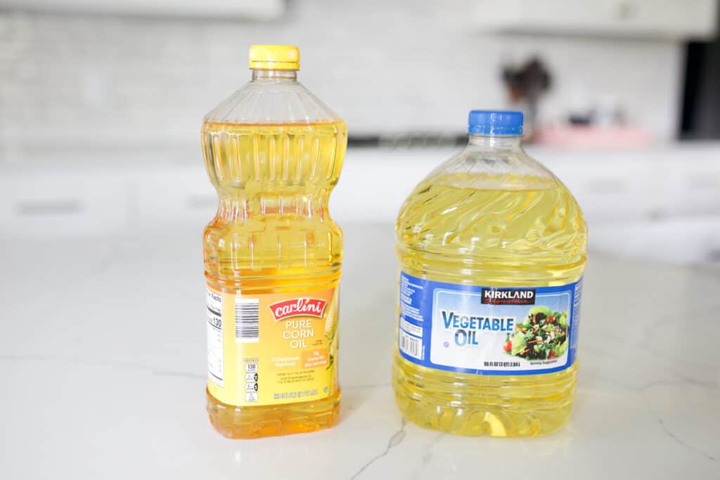 Bottle of corn oil and bottle of vegetable oil.