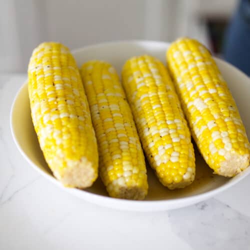 Four pieces of buttery corn on the cob.