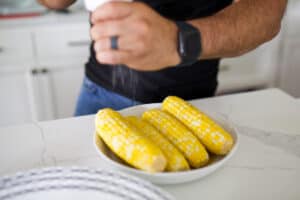 Sous vide corn on the cob with salt being grinded on it by me.