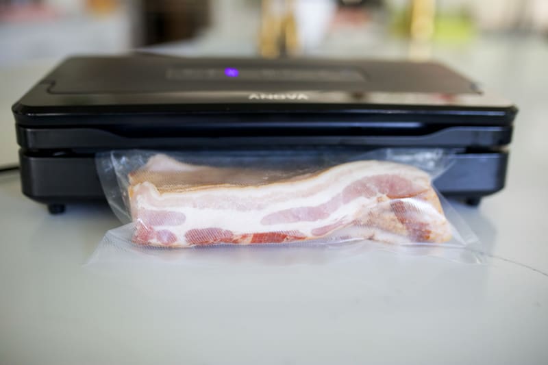 Bacon being vacuum sealed.